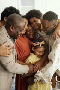 large happy family embracing each other in kitchen