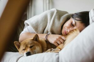 woman sleeping peacefully with dog